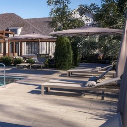 resort style pool with seating trees and a building behind it