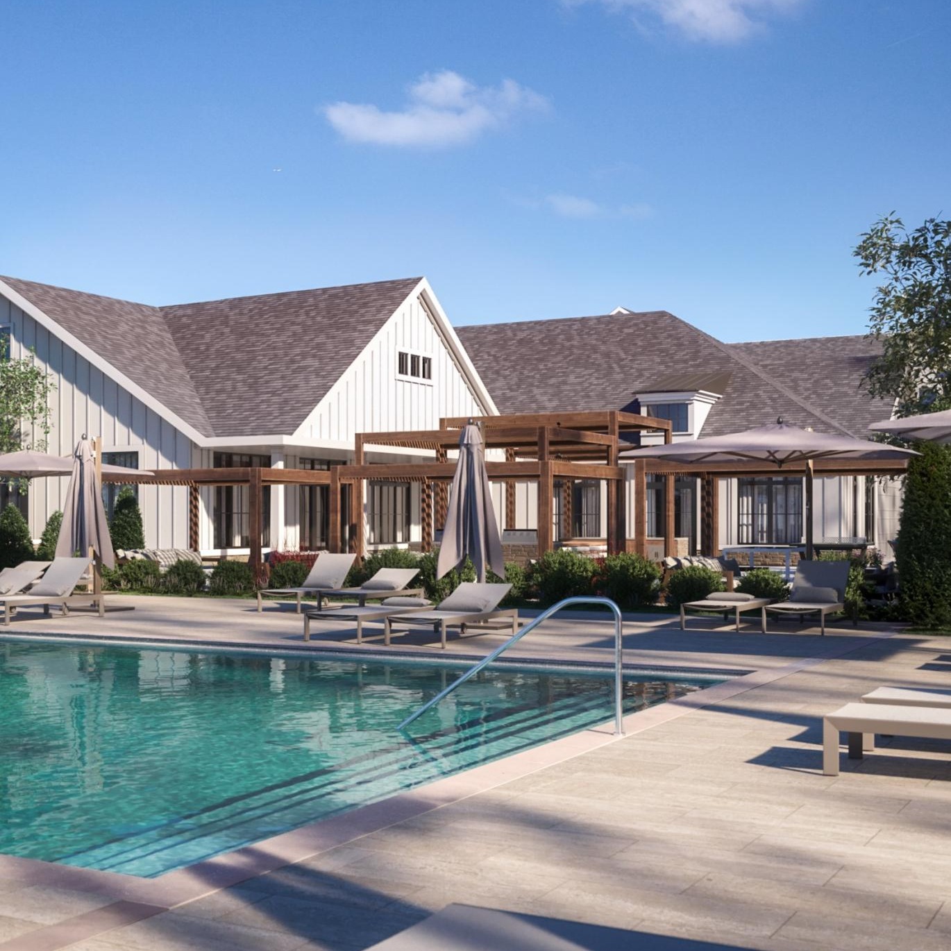 Outdoor swimming pool with lounge chairs at Livana Colts Neck, a brand-new luxury apartment for rent in Colts Neck, NJ.